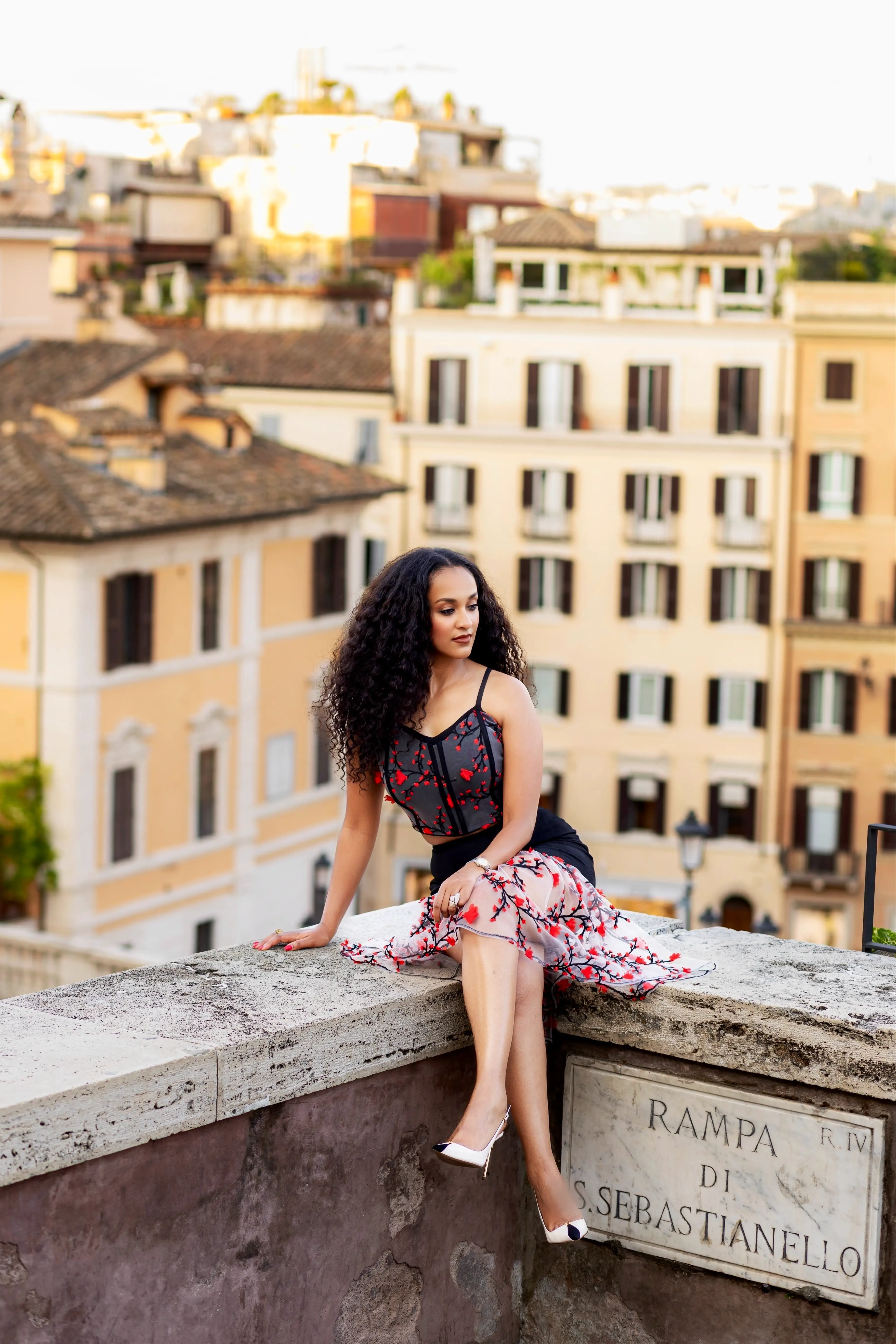 Model posing in the Scarlet Romance design on a stone terrace